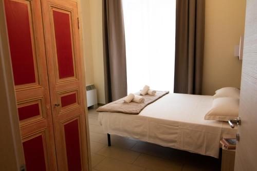 a small bedroom with a bed with towels on it at Santa Giulia Hotel e Residence Torino in Turin