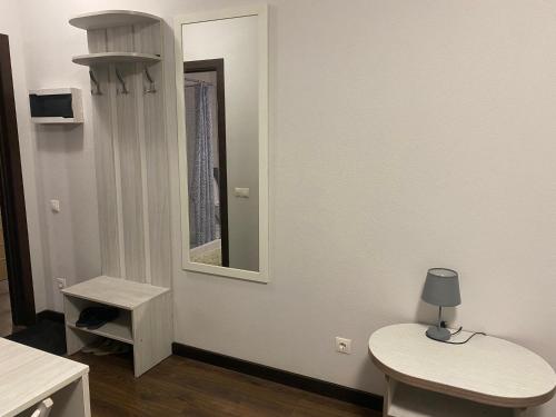 a room with a mirror and a table and a stool at Guest House Olzhycha 45 Б in Kyiv
