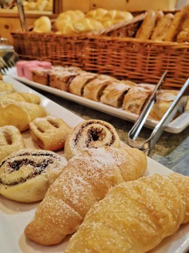 a bunch of pastries on a plate on a table at Hotel Alpina in Rauris