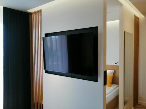 a flat screen tv on a wall in a room at Business Apartment Płock in Płock