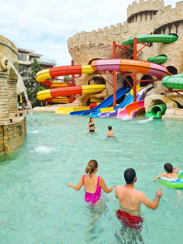 a group of people in the water at a water park at Luxury Dreamland Oasis Apartments in Chakvi
