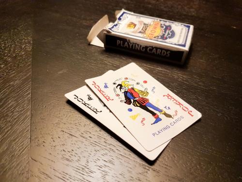a book sitting on a table with a playing cards at Luxury Dreamland Oasis Apartments in Chakvi