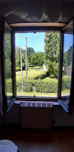 a window in a room with a view of a field at Chez Josie, chambre 18mCarre dans une longère Normande in Francheville