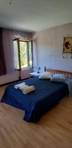a bedroom with a large bed with towels on it at Chez Josie, chambre 18mCarre dans une longère Normande in Francheville