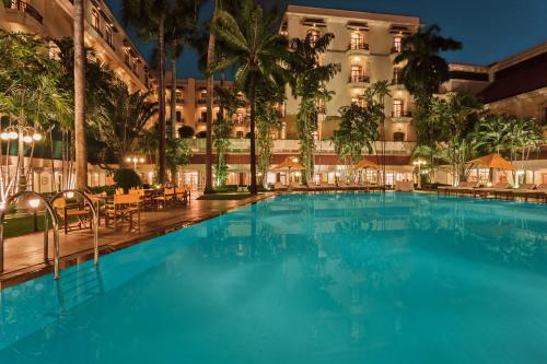 a large swimming pool in front of a building at The Oberoi Grand Kolkata in Kolkata