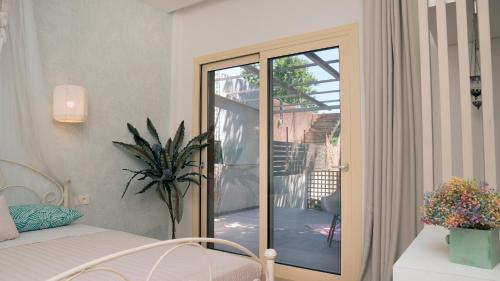 a bedroom with a sliding glass door to a patio at Beach House Lefkes in Plános