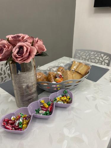 a table with a bowl of food and a vase of flowers at Casa vacanze Figurelle in Naples
