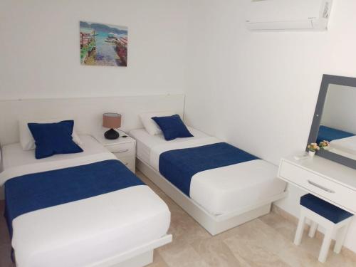 a bedroom with two beds and a mirror at Stone House Aparts 2 plus 1 mit Poolterrasse Kalkan No 2 in Kalkan