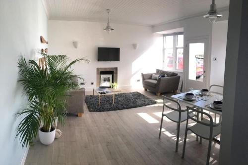 a living room with a table and a couch at The Bolthole in Limekilns