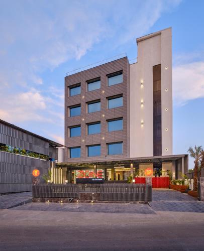 a large building with lights on the side of it at Zone By The Park Pathankot in Pathānkot