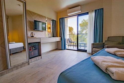a hotel room with a fireplace and a living room at Class Unique Beach in Marmaris