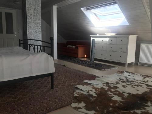 a bedroom with a bed and a dresser and a window at Bei Annerl in Gmunden