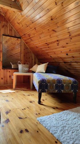 a bedroom with a bed and a wooden ceiling at U źródła. Noclegi w Małym Dólsku in Mały Dólsk