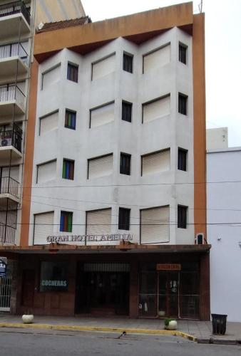 a white building with a sign on the front of it at Gran Hotel Amelia in Mar del Plata