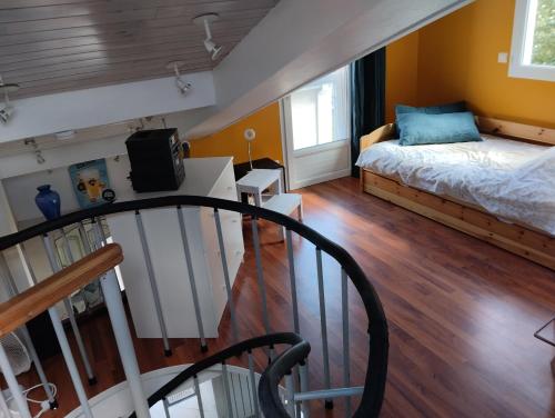 アルカションにあるmaisonnette proche gare et plagesのベッドと階段が備わる小さな客室です。