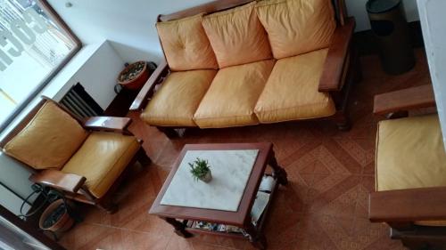 an overhead view of a living room with a couch and a table at Gran Hotel Amelia in Mar del Plata
