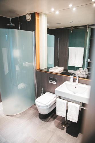 a bathroom with a toilet and a sink and a shower at Sankt Jörgen Park in Gothenburg