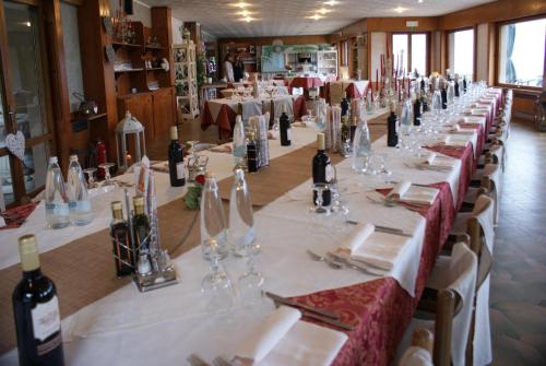 a long table with wine bottles and glasses on it at Hotel Mirabeau in Bellagio