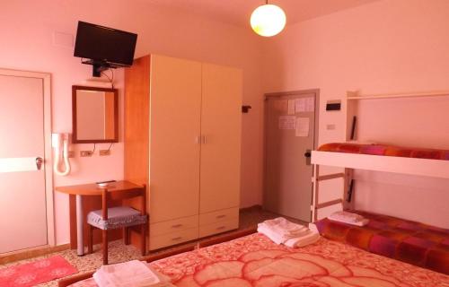 a bedroom with a bunk bed and a desk at Hotel La Vela in Bellaria-Igea Marina