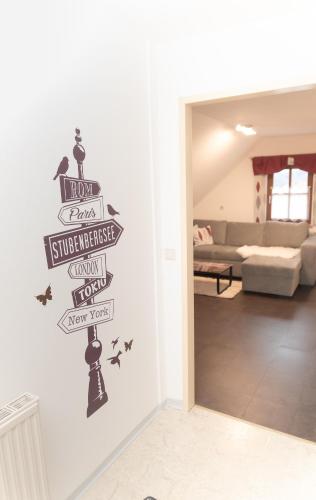 a living room with a sign on the wall at Haus Rosy Ferienwohnung in Stubenberg