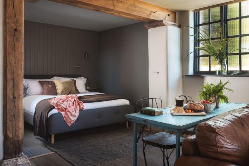 a bedroom with a bed and a table at Exe Valley Retreat in Exeter