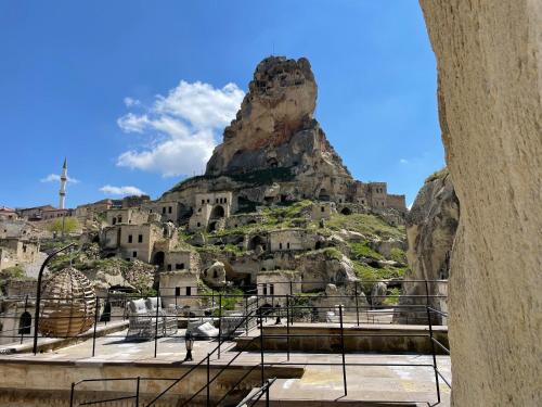 a view of a rock formation with a mountain at Doctor's Cave Cappadocia in Ürgüp
