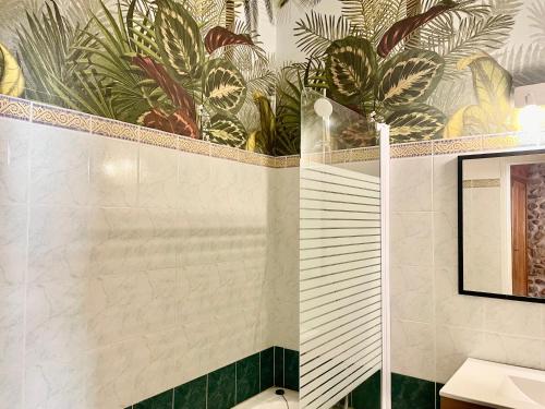 a bathroom with a mural of plants on the wall at LE CLOS D'ALET in Alet-les-Bains