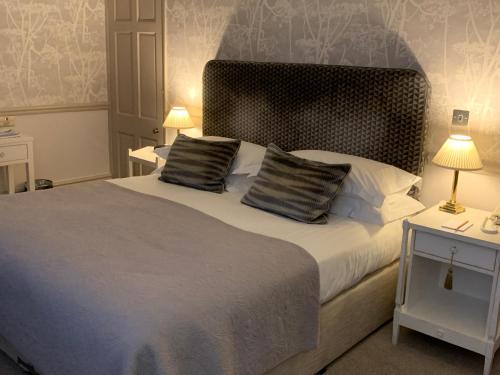 a bedroom with a large bed with two pillows at Watersmeet Hotel in Woolacombe
