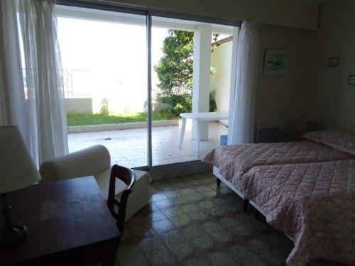 une chambre avec un lit et une grande fenêtre dans l'établissement Appartement T2 avec terrasse et parking à Arcachon - FR-1-374-78, à Arcachon