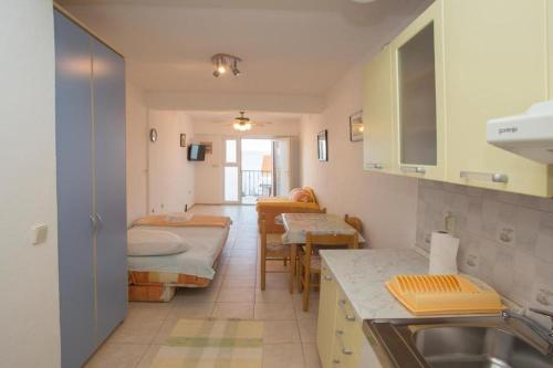 a kitchen with two beds and a sink in a room at Serenity near the sea in Okrug Gornji