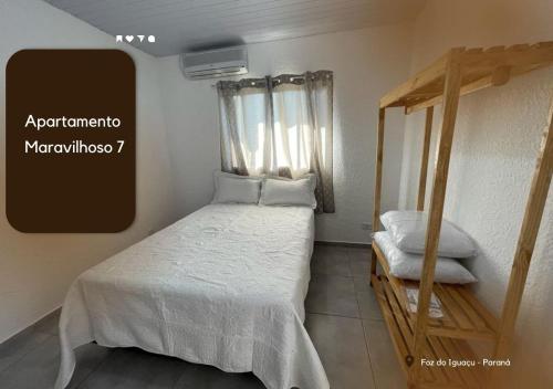 a small bedroom with a bed and a window at APARTAMENTO MARAVILH... 7 in Foz do Iguaçu