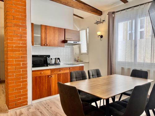 a kitchen and dining room with a wooden table and chairs at Casa Italia in Prague