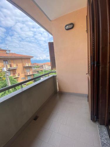 a room with a balcony with a clock on the wall at Casa Vacanze Fiore in Omegna