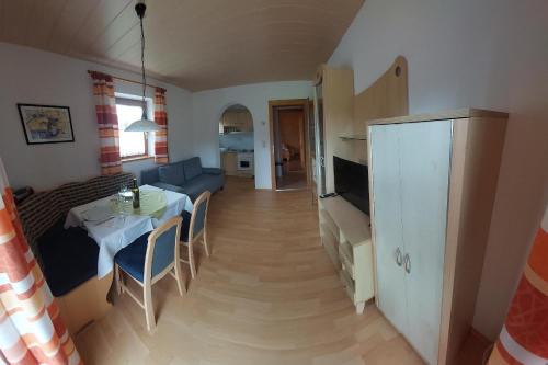 a small living room with a table and a couch at Appartements Bodenland in Wildschönau