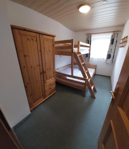 a small room with a bunk bed and a closet at Appartements Bodenland in Wildschönau