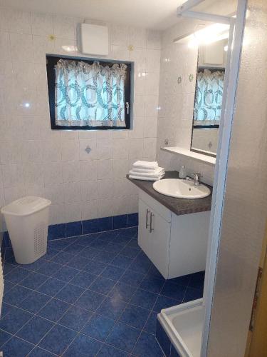 a bathroom with a sink and a toilet and a mirror at Appartements Bodenland in Wildschönau