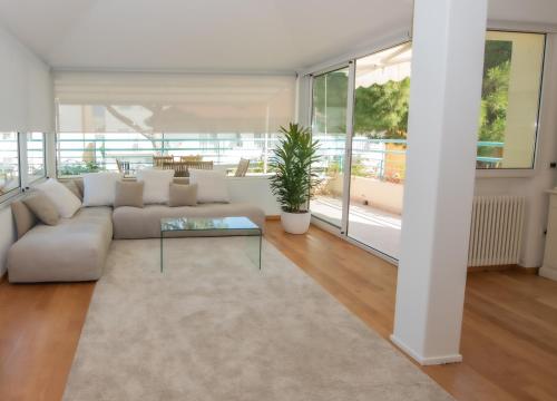 sala de estar con sofá y mesa de cristal en Luxury Suites Collection - Organza en Riccione