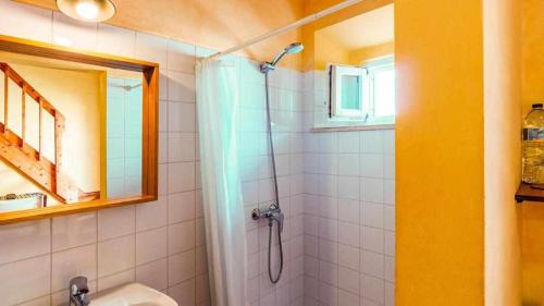 a bathroom with a shower and a sink at Casa Presente Guesthouse in Carrapateira