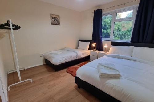a bedroom with two beds and a window at 2 Bedroom apartment in Kennington London in London