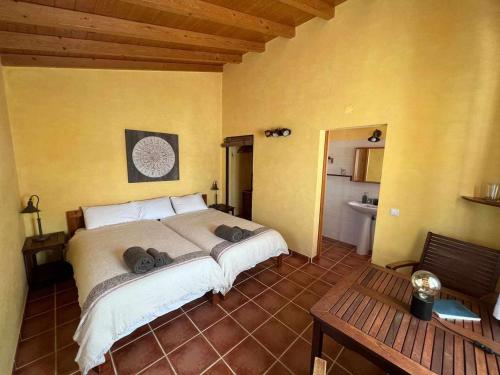 a bedroom with a large bed in a room at Casa Presente Guesthouse in Carrapateira