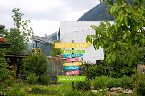 a sign with many different signs in a garden at Haus Viktoria in Mayrhofen