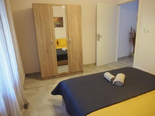 a bedroom with a bed and a large mirror at Apartments dimitra in Kanallákion