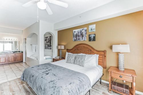a bedroom with a large bed and a bathroom at Pirate Ship Resort Condo in Orlando