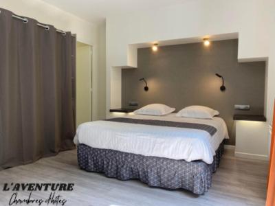 a bedroom with a large bed in a room at l'Aventure in Morcenx