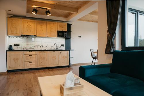 a living room with a couch and a table at Apartamenty Górajski Spa in Kościelisko