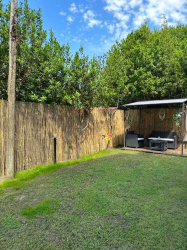 a backyard with a fence and a shed at Jo's House in Calambrone