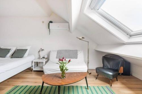 a room with a table and a bed and a chair at African heritage Tervuren in Tervuren