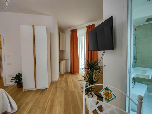 a living room with a flat screen tv on a wall at AquaMar Bed and Breakfast in Crotone