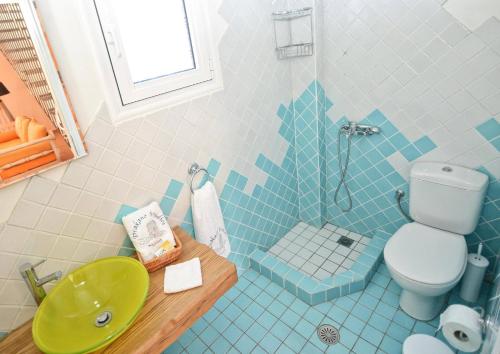 a bathroom with a toilet and a sink and a shower at Timessa Mezonette - Agios Kirikos in Agios Kirykos