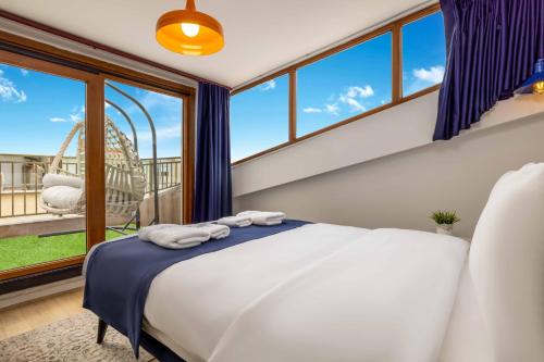 a bedroom with a bed and a large window at Monnas Suite in Istanbul